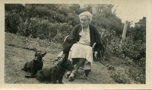 Unidentified woman with Scottish terriers