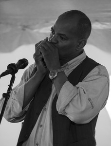 Guy Davis playing harmonica during the Clearwater Folk Festival