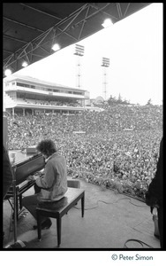 Bob Dylan playing piano on stage at Bill Graham's SNACK (Students Need Athletics, Culture and Kicks) benefit concert, Kezar Stadium