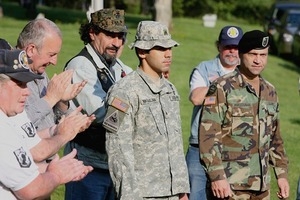 Vietnam veterans applaud two Iraq War veterans, Tigran (cq) Mikaelian (cq), Providence and David Harootunian (cq), Seekonk, at the end of the dedication ceremony for the Vietnam War memorial