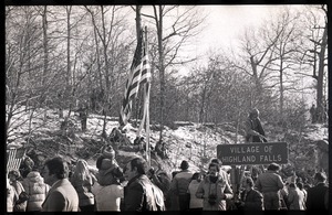 Crowd gathered to greet the Iran hostages at Highland Falls, N.Y., near road sign for Village of Highland Falls