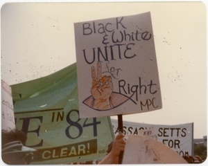 Demonstration with banners and sign reading 'Black and white unite for right'