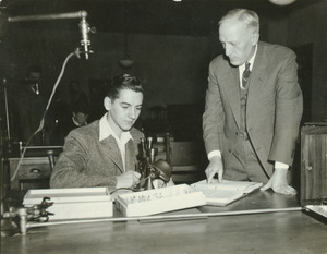 Charles P. Alexander sitting at a study table