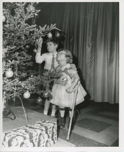 Children decorating Christmas tree