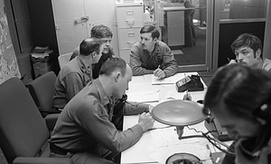 Unidentified men and officers in conference room