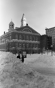 Snow piles and pedestrians in front of Faneuil Hall