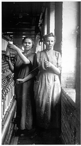 Two female textile workers at a spinning frame. [09]