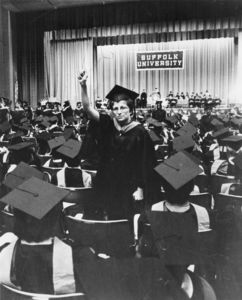 A graduate raises a coat hanger in protest of anti-abortion efforts at the 1978 Suffolk University commencement