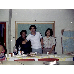 One male and two female staff members at a party at La Alianza Hispana, Boston
