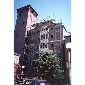 Facade of the newly constructed Taino Tower is being given the finishing touches by a worker high up on the scaffolding.