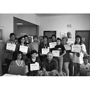 Group portrait of people holding Certificates of Participation.