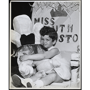 Marianne Connolley, 3, Miss South Boston of 1968, sitting on her throne with a stuffed animal