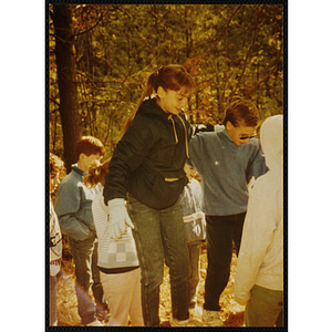 A girl and a boy balance on a tightrope outdoors