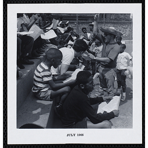 A group of boys participate in a sing-along on Tom Sawyer Day