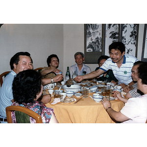 Men and women sit around a restaurant table during a CPA tour of China