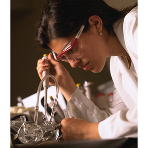Co-op student using a dropper in a lab