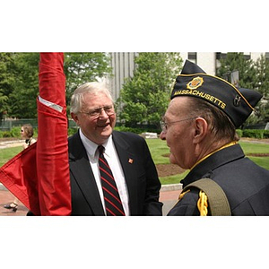 Neal Finnegan speaks with a man in uniform at the Veterans Memorial groundbreaking ceremony