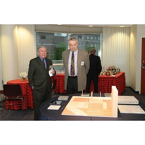 Two men look at an architectural model of the Veterans Memorial at the dinner
