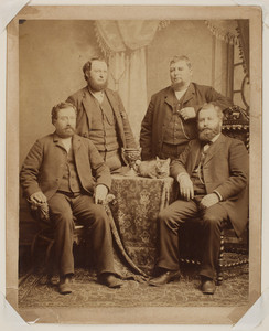 Group portrait of four unidentified men with cat, undated