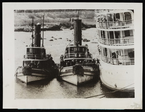 The S. S. New York is assisted by two tugboats after running aground