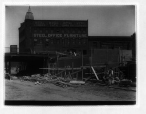 View of construction site in front of Steel Office Furniture building