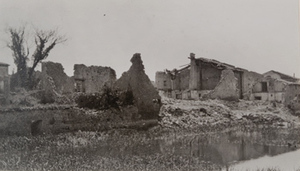 Ground-level view of destroyed stone buildings