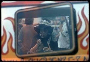Woman seen through the window of a food truck at the Woodstock Festival