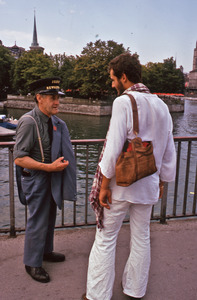 Two men chatting by the river's edge