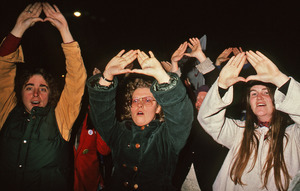 Women making the women sign with their hands