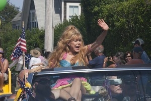 Grand Marshall Charo riding in the parade, waving to the crowd : Provincetown Carnival parade