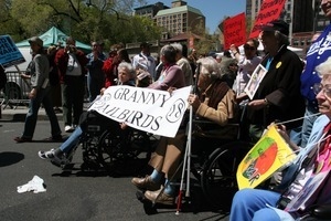 Granny Jailbirds with the banner, several in wheelchairs, during the protest against the war in Iraq