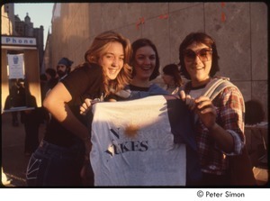 MUSE concert and rally: three young women holding a 'no nukes' t-shirt