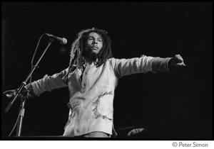 Bob Marley in concert, arms spread out