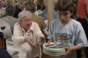 Church supper at the First Congregational Church, Whately: young boy busing tables