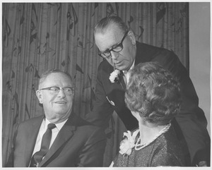 Earl Eastman Lorden and wife Marian Lorden sitting indoors, speaking to Warren P. McGuirk at 1966 Testimonial Dinner for Earl Lorden