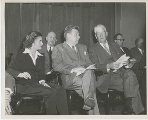 Arthur Godfrey seated on stage with clients and staff at Institute Day