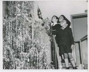 Young clients decorating Christmas tree