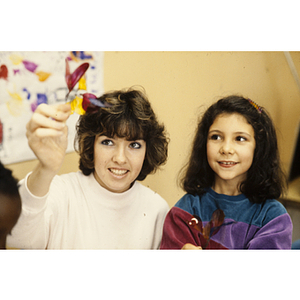 Woman showing an art project to a child