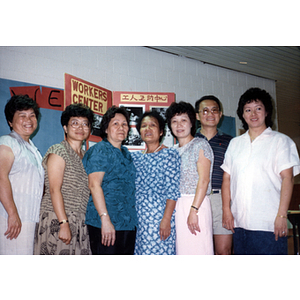 Group portrait in front of Workers' Center display