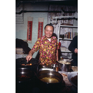 Man stands behind a buffet table