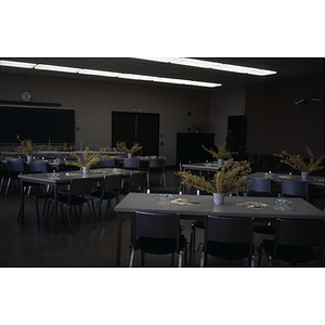 Empty tables with floral displays at Faculty Wives luncheon