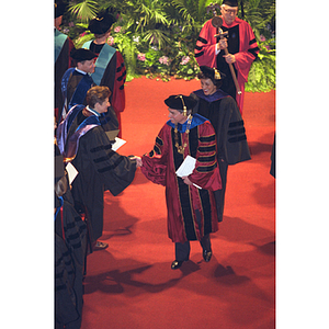 President Freeland shakes hands with a faculty member at his inauguration ceremony