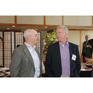 Two men converse at the Training Future Innovators Entrepreneurs Panel