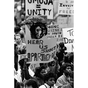 Students hold signs during an anti-apartheid demonstration in the quadrangle