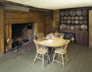 View of the kitchen showing fireplace, table and pewter cupboard, Coffin House, Newbury, Mass.