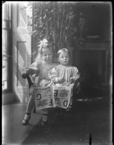 Portrait of two children with alphabet book