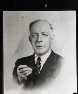 Henry A. Ellis and the doughnut: studio portrait of Ellis