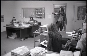 Darlene Cobleigh, Mike Scanlon, and Bruce Geisler and unidentified woman with back to camera (l. to r.) in office
