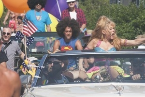 Grand Marshall Charo riding in the parade, waving to the crowd : Provincetown Carnival parade