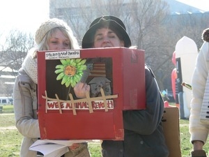 Protesters on the National Mall with puppet theater box, marching against the War in Iraq